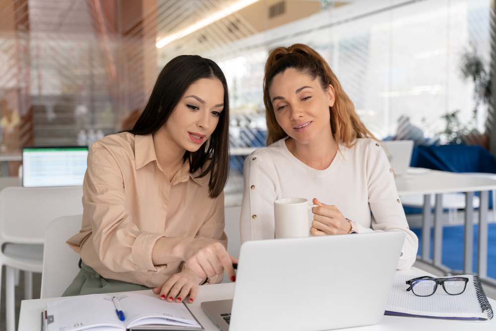 two person in the laptop with the coffee searching for SEO services